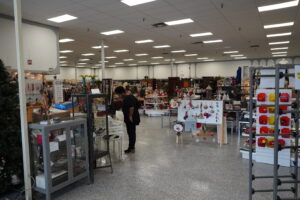Inside the store showing display racks of clothing, jewelry, home decor, and more.