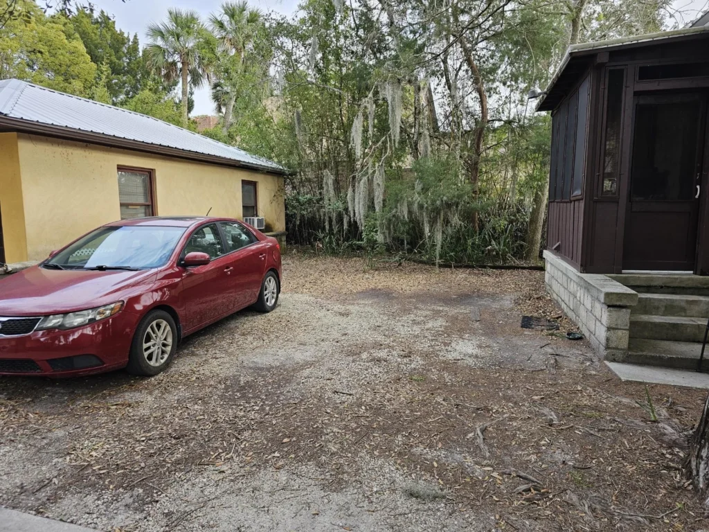 Designated parking is the space next to the back porch of the house next door.