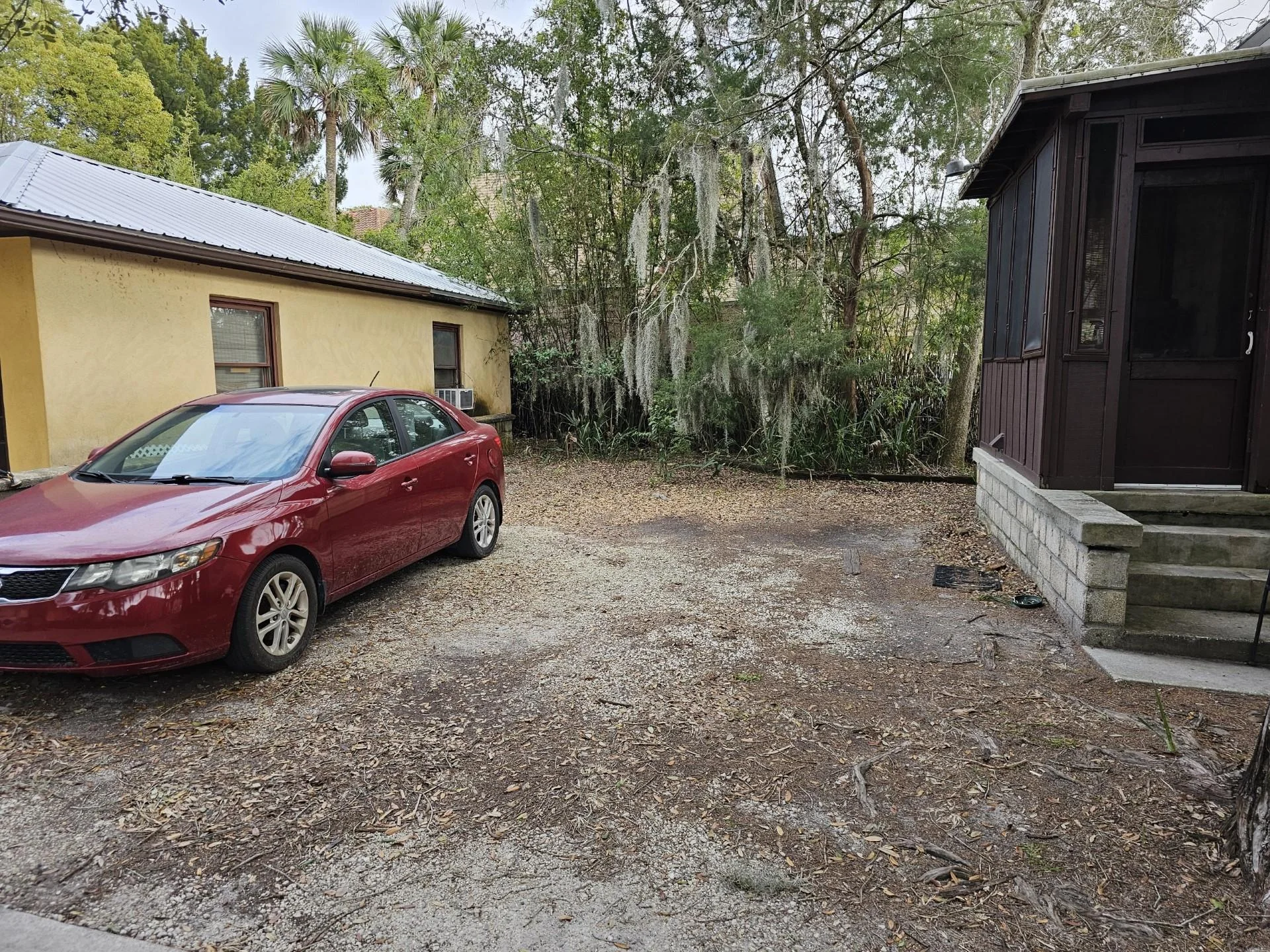 Designated parking is the space next to the back porch of the house next door.
