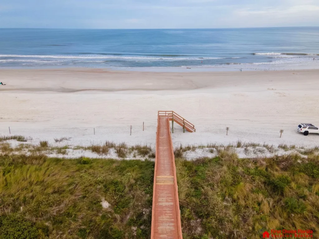 Scenic boardwalk leading to a serene, expansive beach!