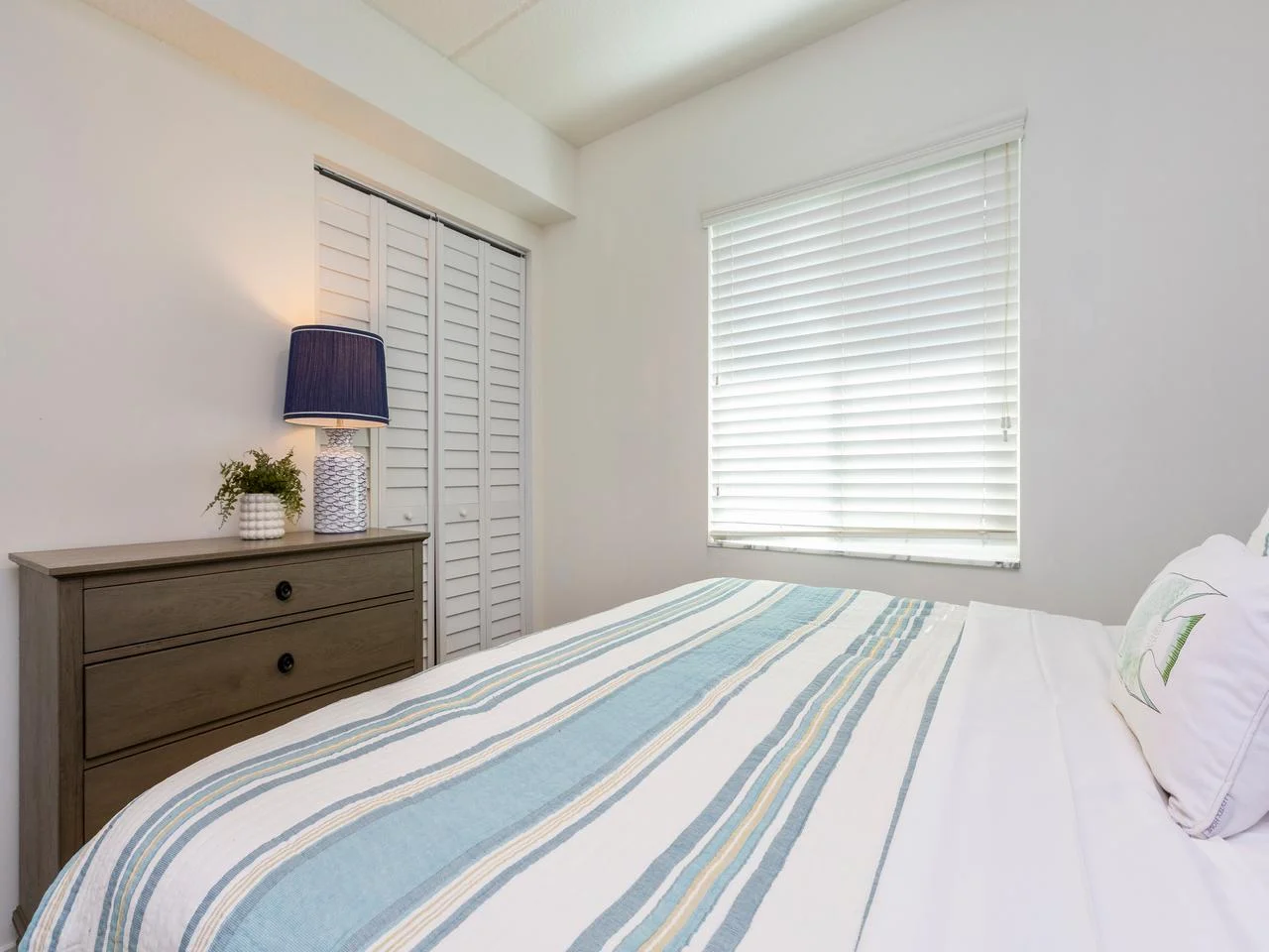 Bright and cozy guest king bedroom with calming natural light!
