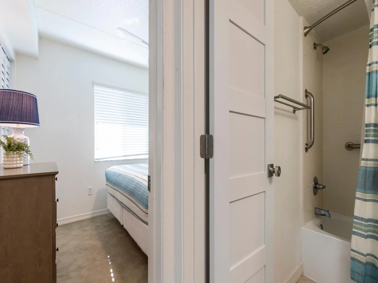 Bright, cozy bedroom with modern bathroom access