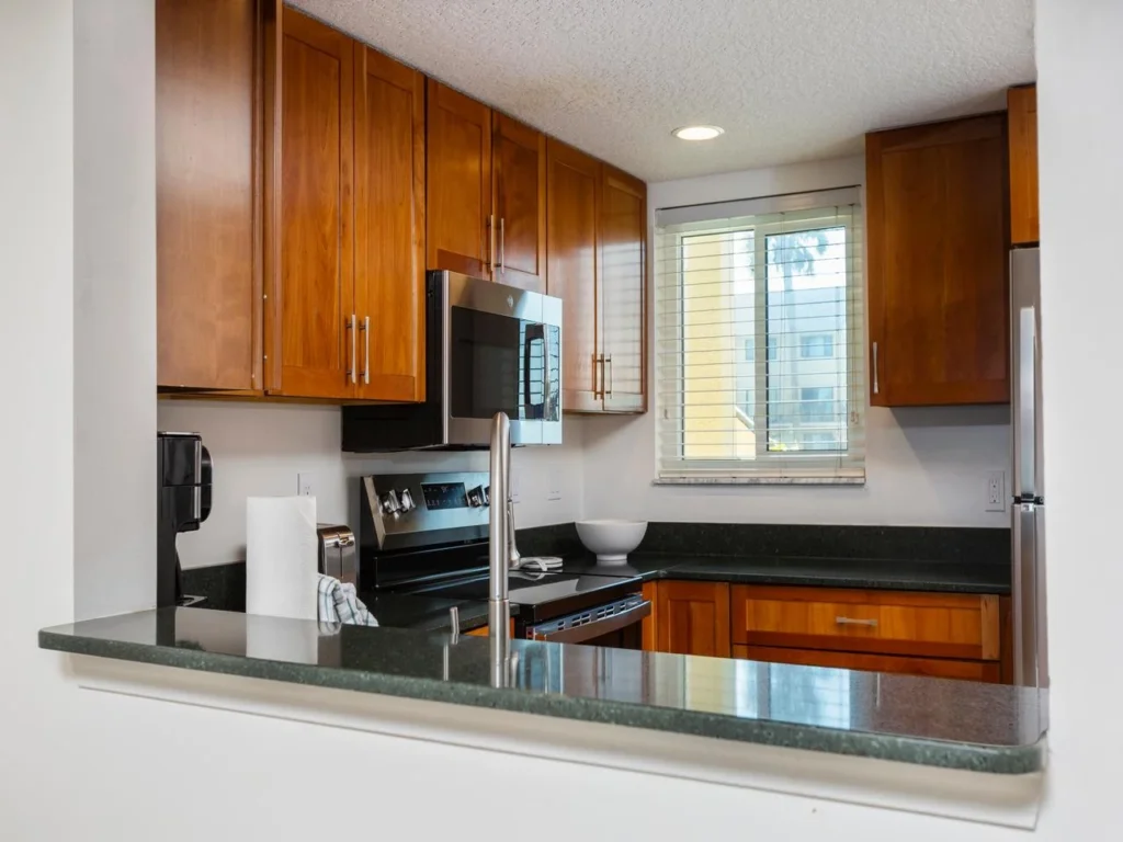 Modern kitchen with sleek appliances and warm wood cabinetry!