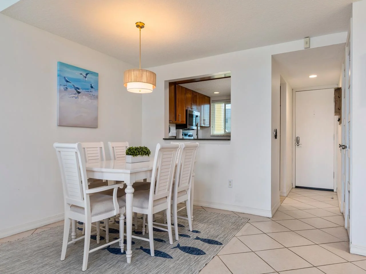 Bright dining area with cozy seating and open kitchen view!
