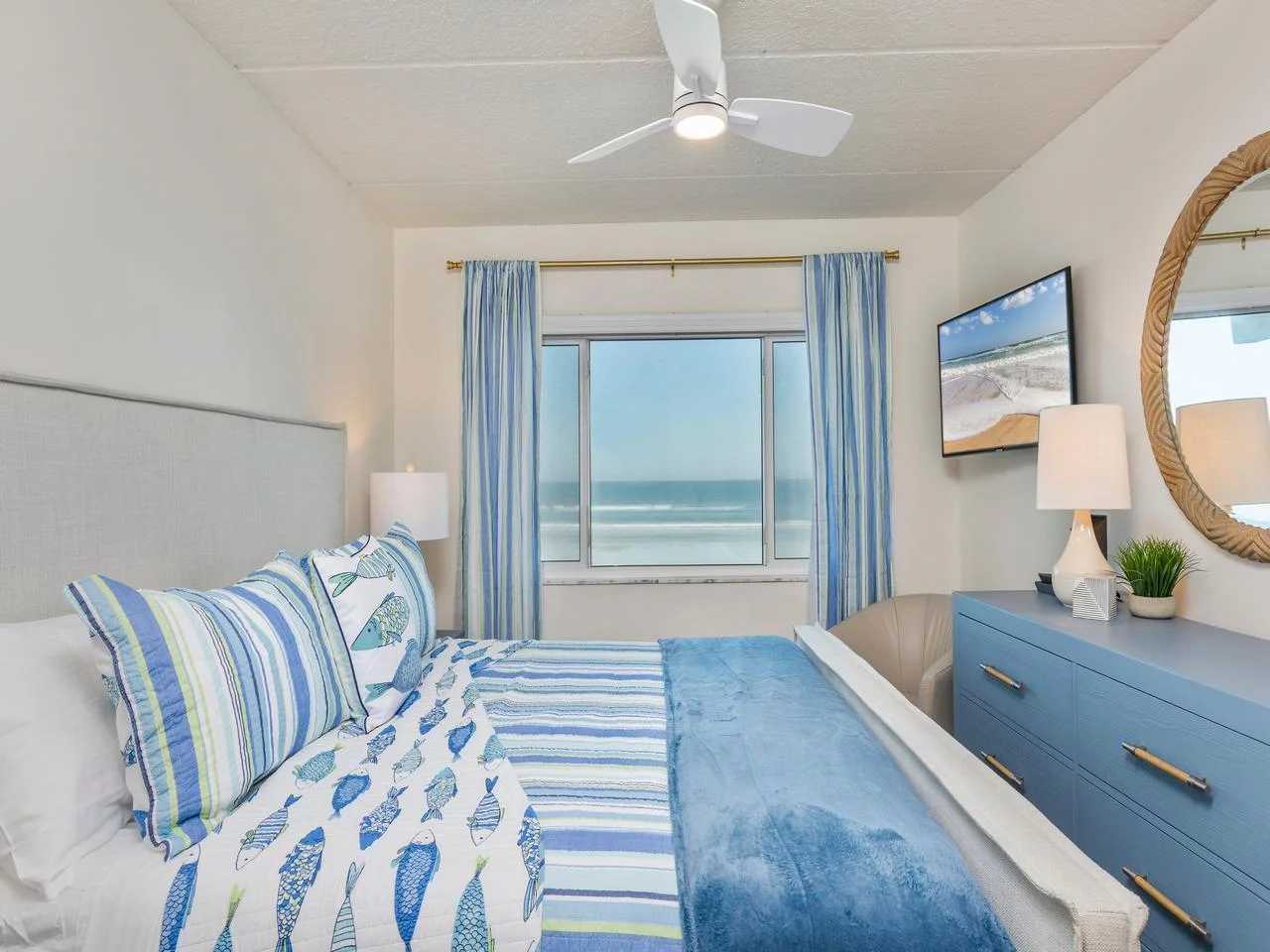Cozy primary bedroom with ocean views and soothing coastal decor!