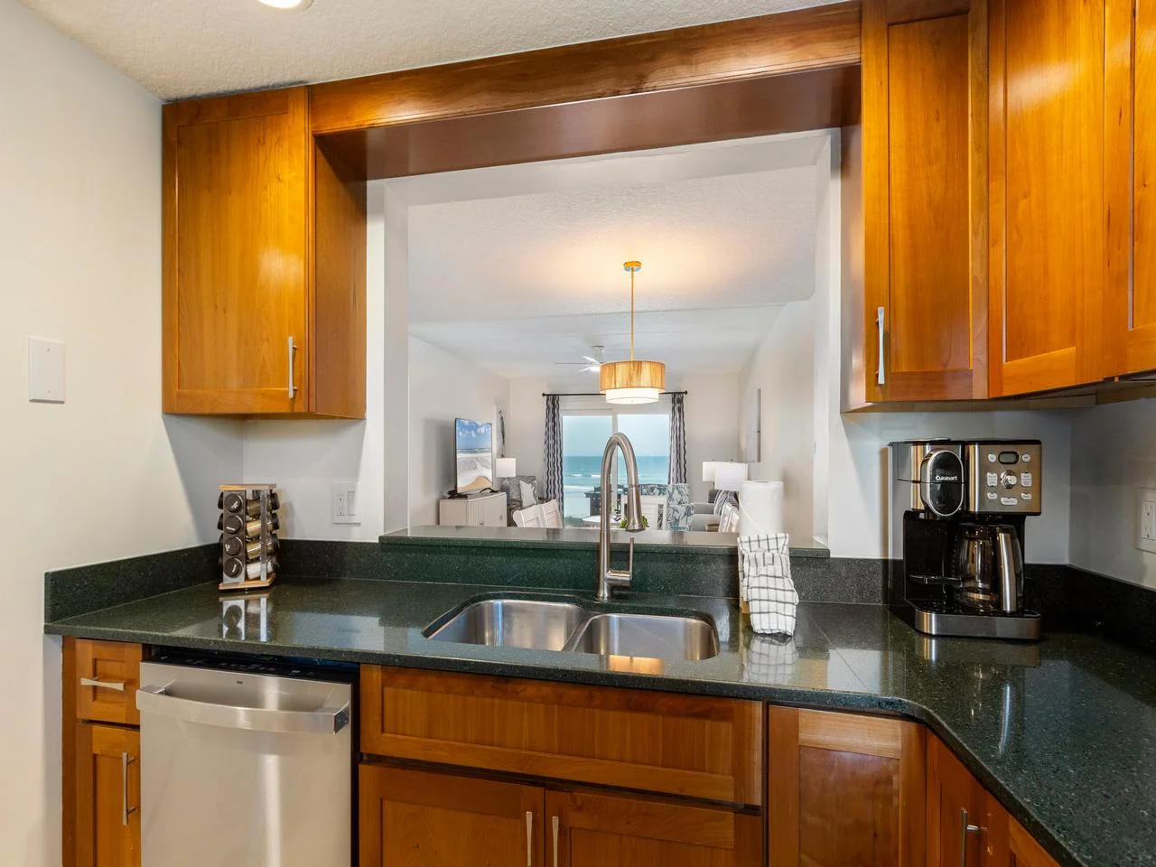 Modern kitchen with sleek countertops and warm wood cabinetry!
