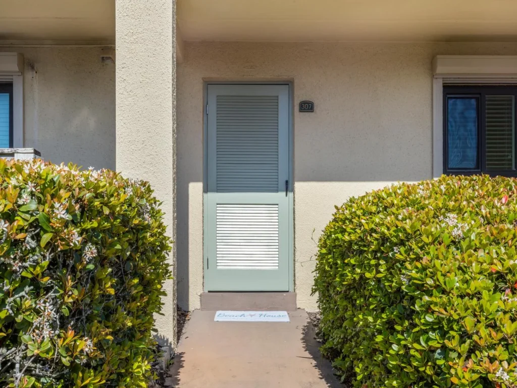 Cozy entryway framed by lush greenery!