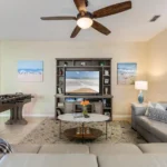 Spacious family room with reclining leather sectional seating and foosball table!