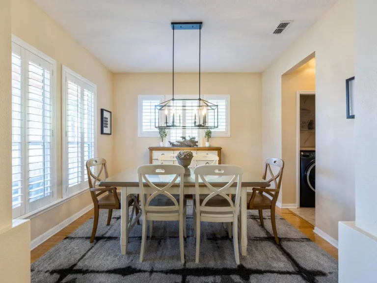Bright dining room with elegant chandelier and natural light!