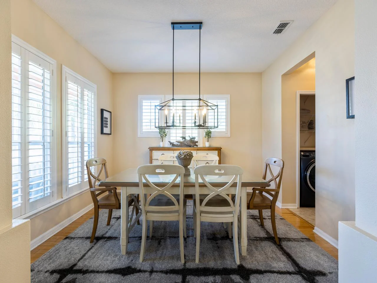 Bright dining room with elegant chandelier and natural light!