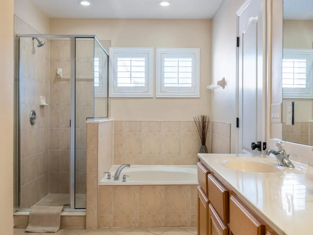 Bright bathroom with spacious tub and glass shower enclosure!