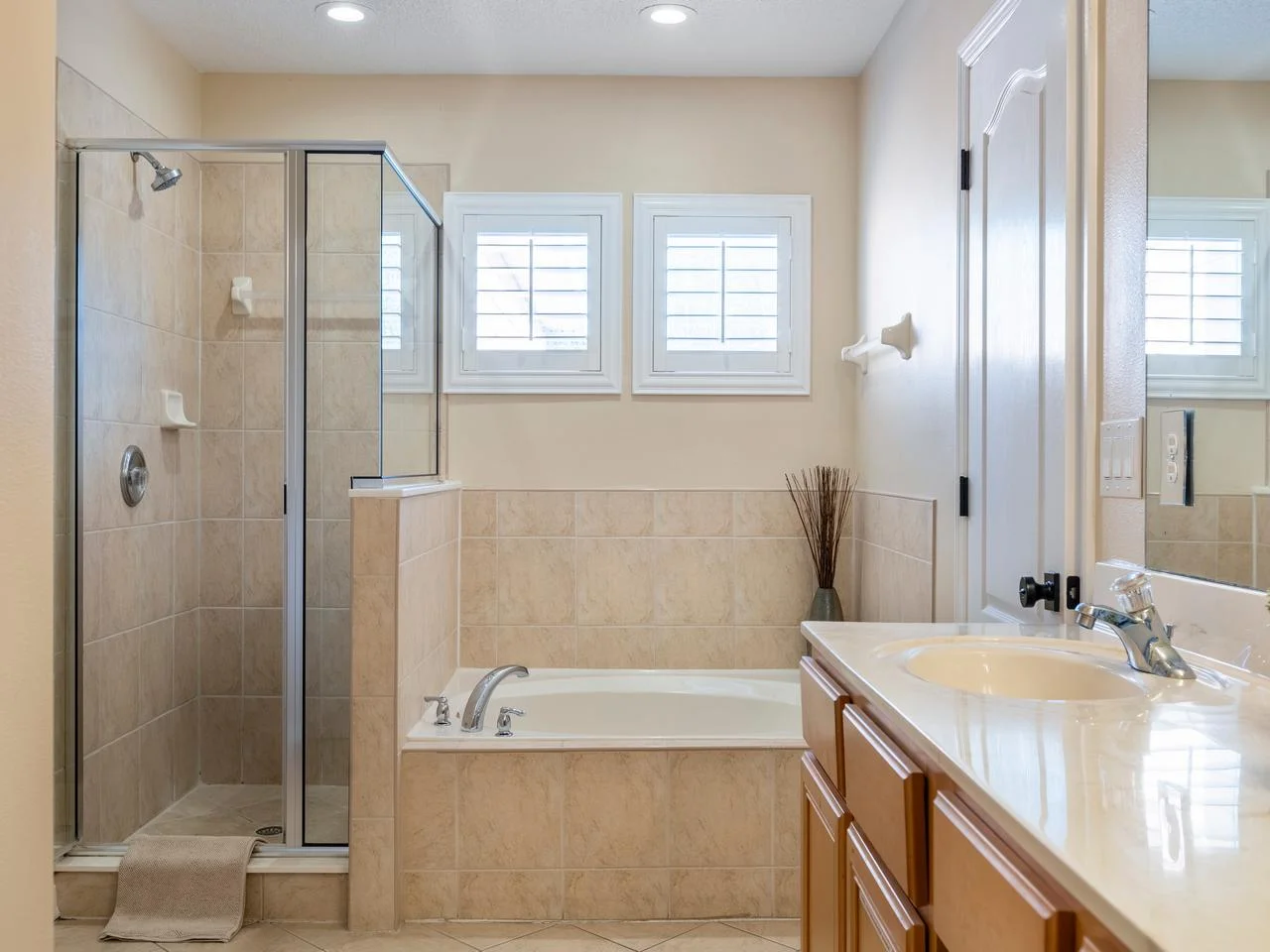 Bright bathroom with spacious tub and glass shower enclosure!