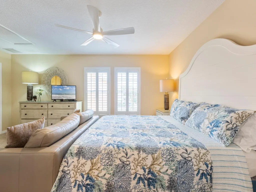 Sunlit bedroom retreat with cozy coastal charm and seating area!