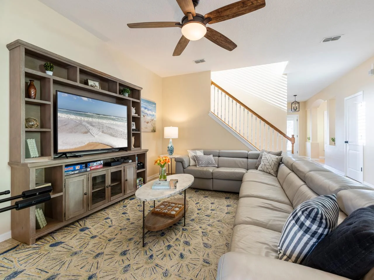 Spacious family room with cozy reclining sectional and entertainment center!