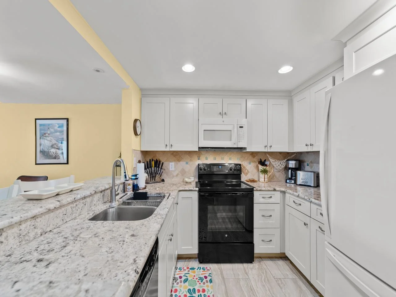 Bright, modern kitchen with granite countertops and ample storage