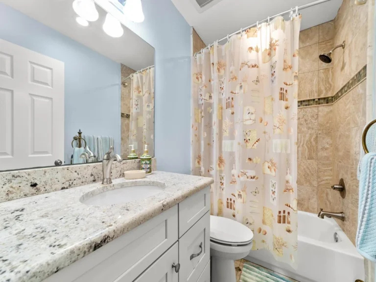 Bright and airy guest bathroom with granite countertop and tub/shower combo!