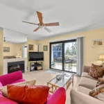 Bright living room with cozy seating and garden views