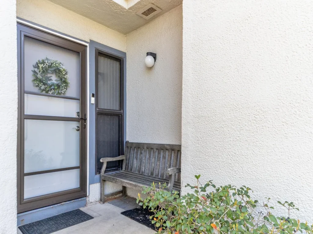 Welcoming entryway with modern door and cozy bench seating