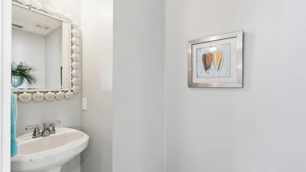 Second-floor powder room with a white pedestal sink.
