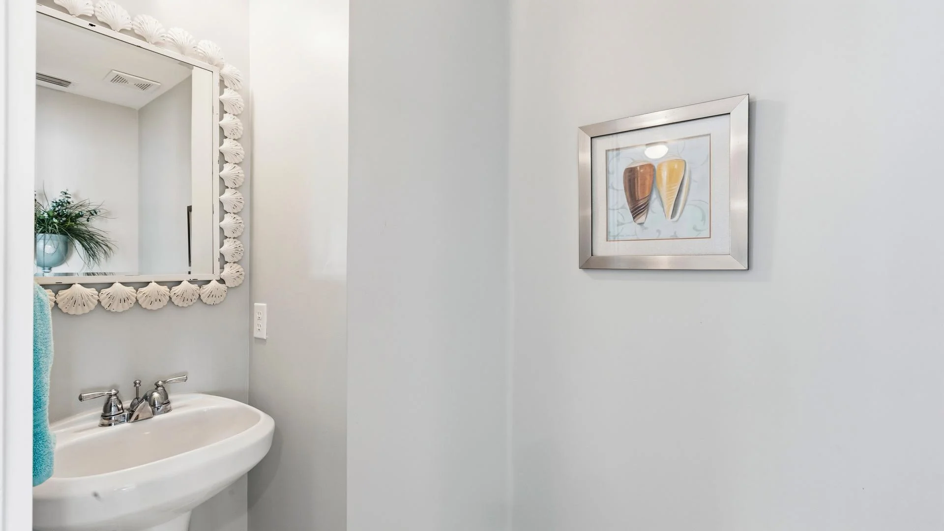 Second-floor powder room with a white pedestal sink.