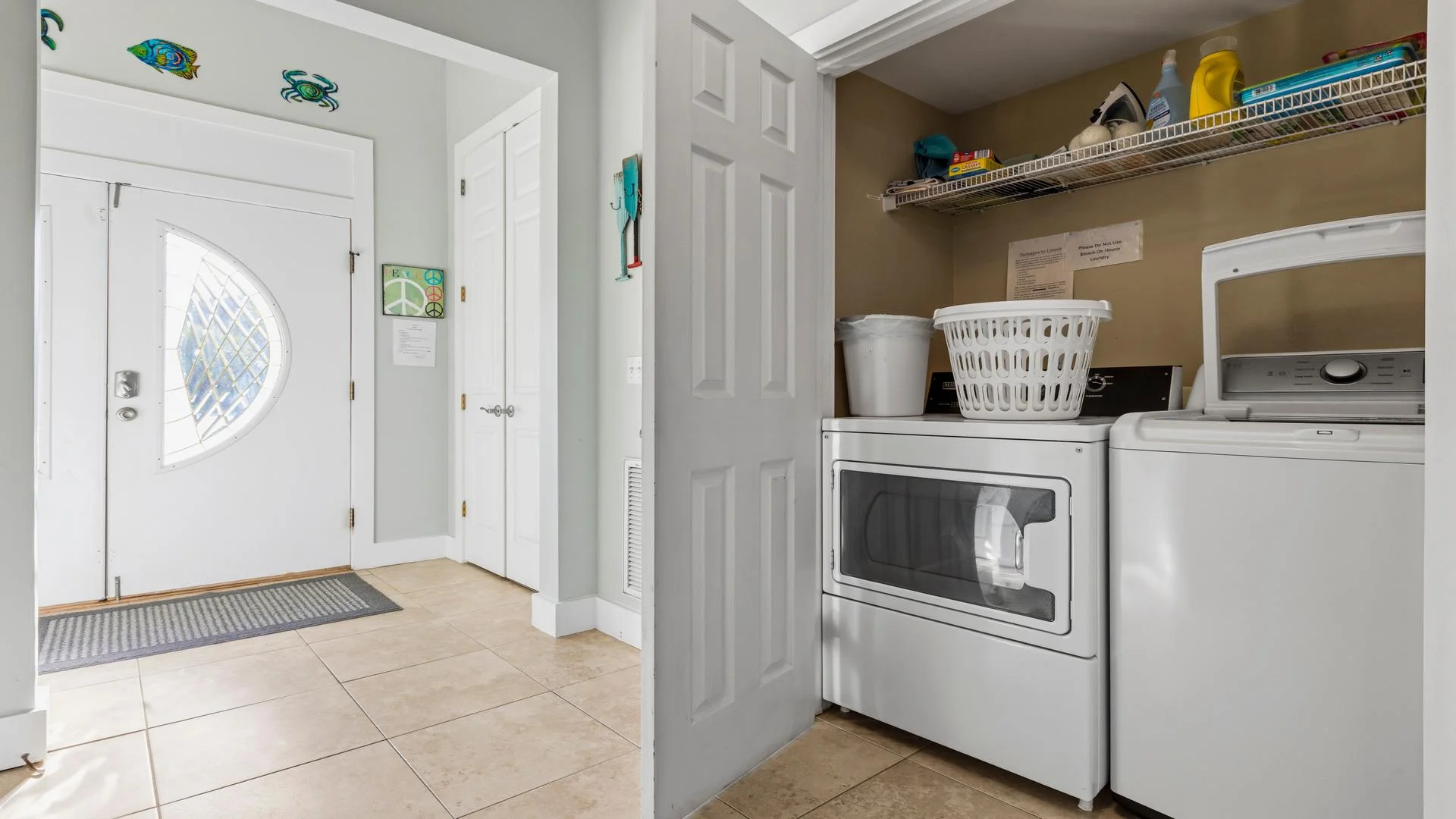 First-floor laundry closet with stacked washer and dryer.