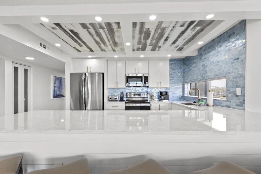 Sleek modern open kitchen with sparkling quartz countertops and stainless steel appliances