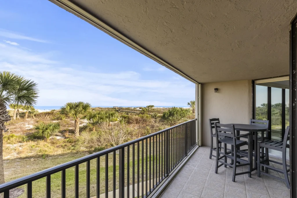 Spacious balcony with scenic views and cozy seating area