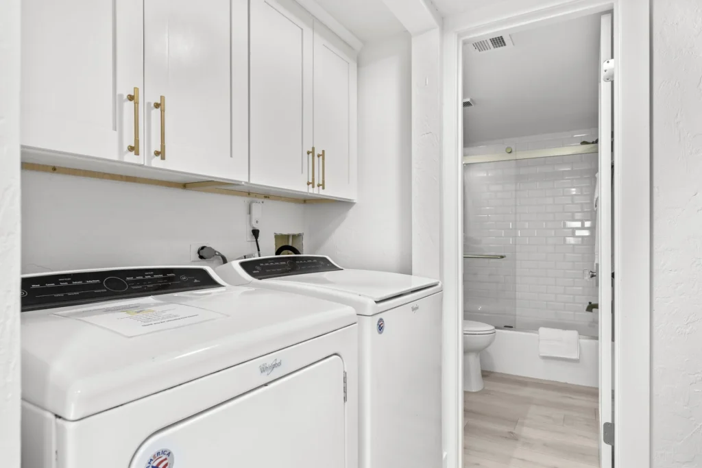 Conveniently located washer and dryer with ample storage cabinets