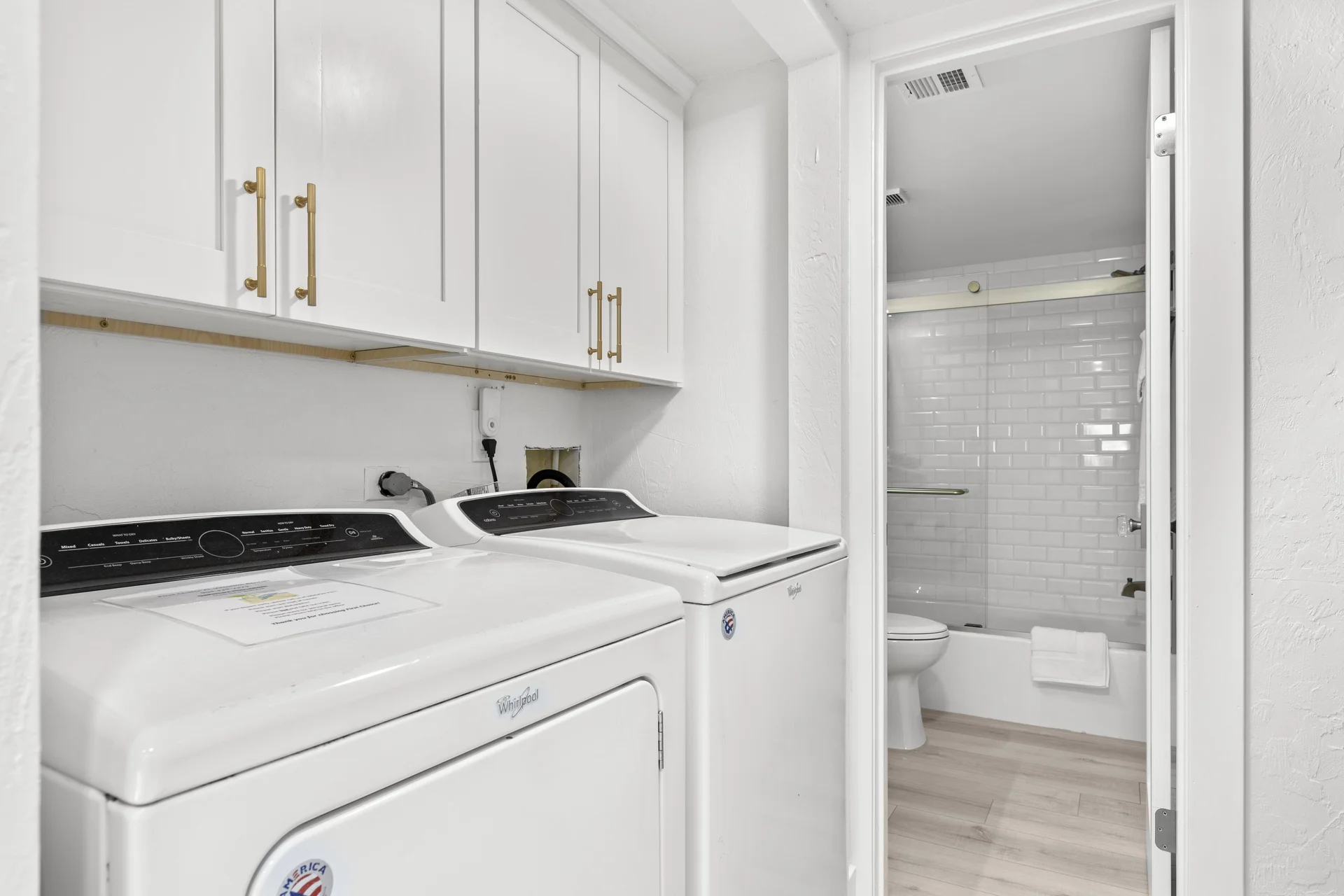 Conveniently located washer and dryer with ample storage cabinets