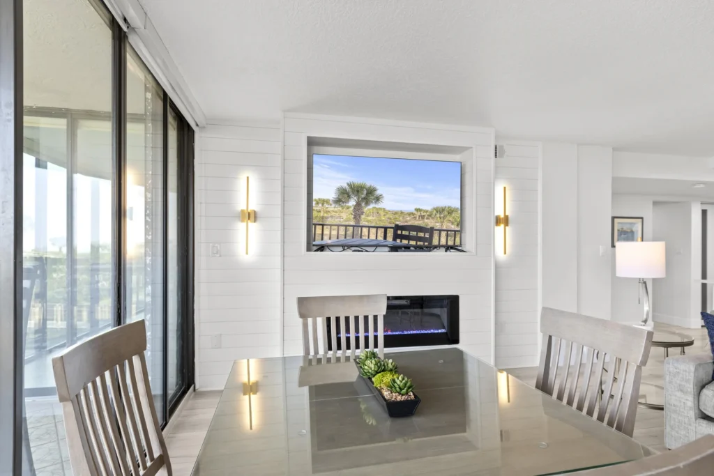 Sunlit dining area with cozy fireplace and scenic views