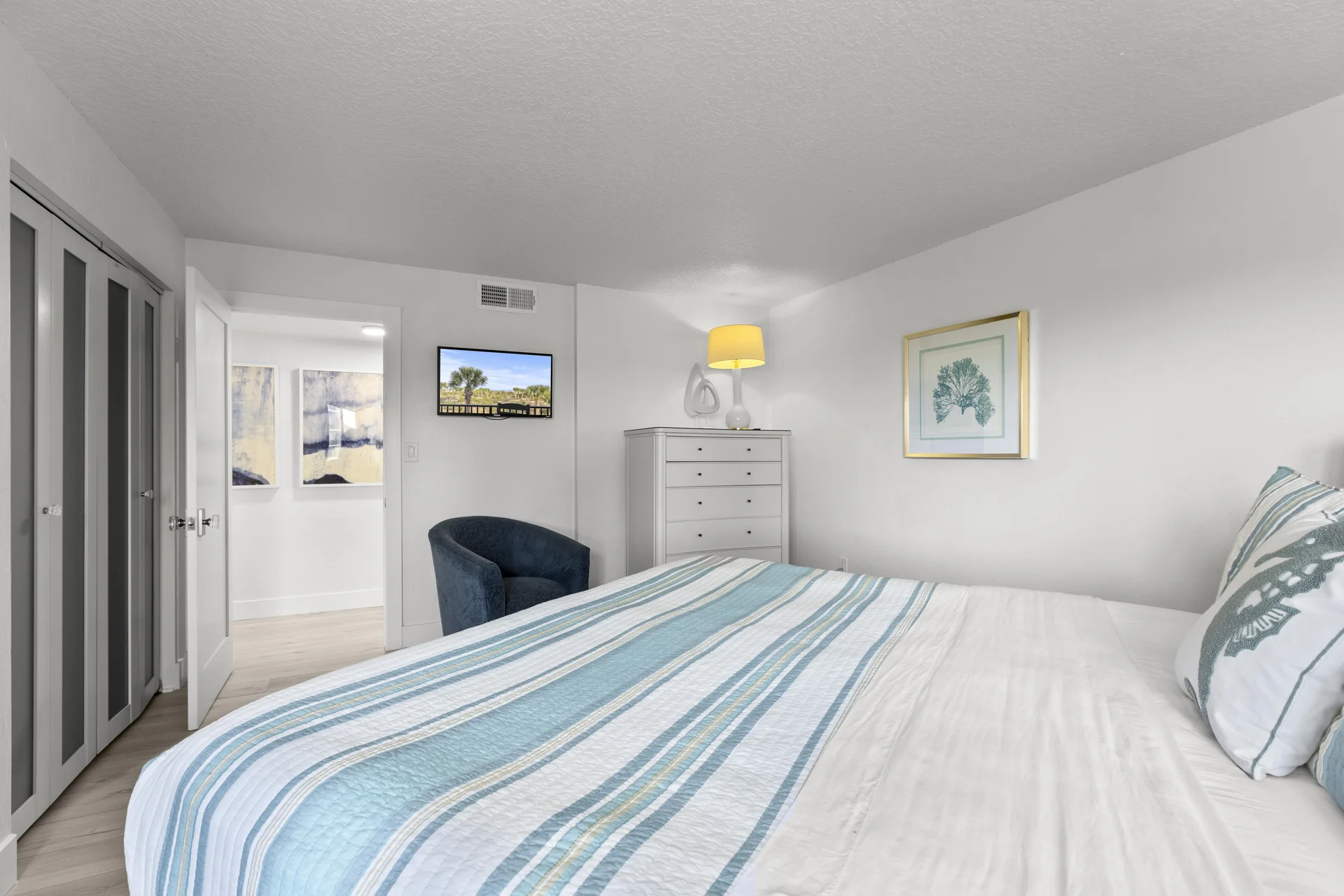 Second bedroom with coastal-inspired decor and smart TV