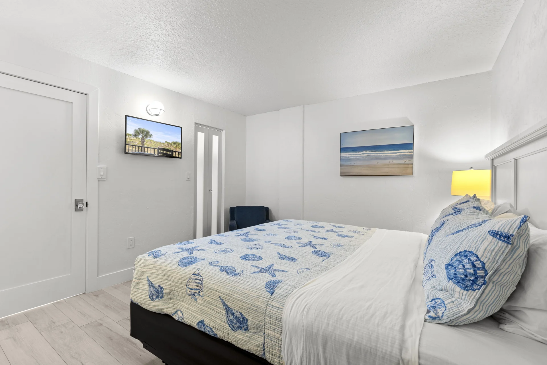 Third bedroom retreat with calming coastal decor, 32 inch smart TV and a comfy chair for reading