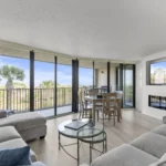 Spacious living room with panoramic windows, cozy fireplace and 65 inch Smart TV
