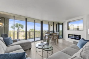 Spacious living room with panoramic windows, cozy fireplace and 65 inch Smart TV