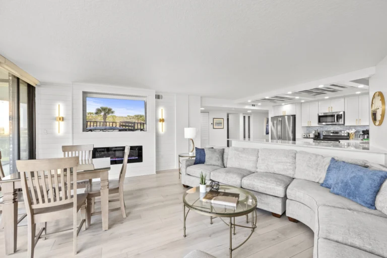 Open concept floor plan. Bright and airy living room with cozy sectional and ocean views.