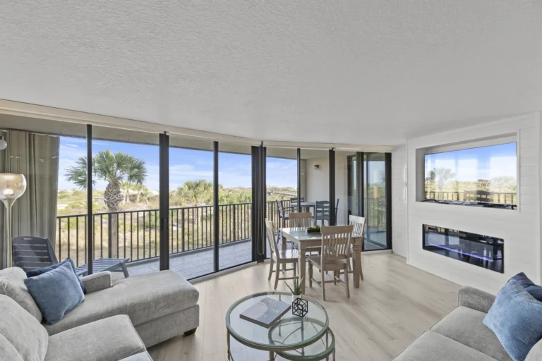 Sunlit living room with panoramic views, cozy fireplace and 65 inch Smart TV