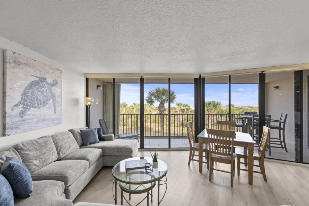 Sunlit living and dining area with panoramic ocean views