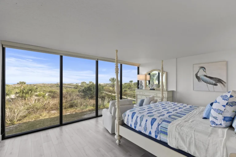 Primary bedroom with panoramic dune to oceanviews and coastal breeze