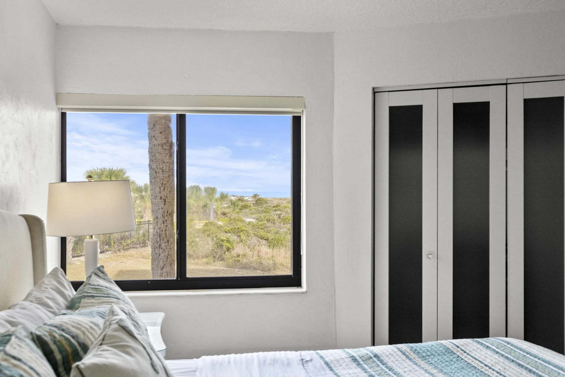 Second bedroom with scenic ocean views and cozy king bed