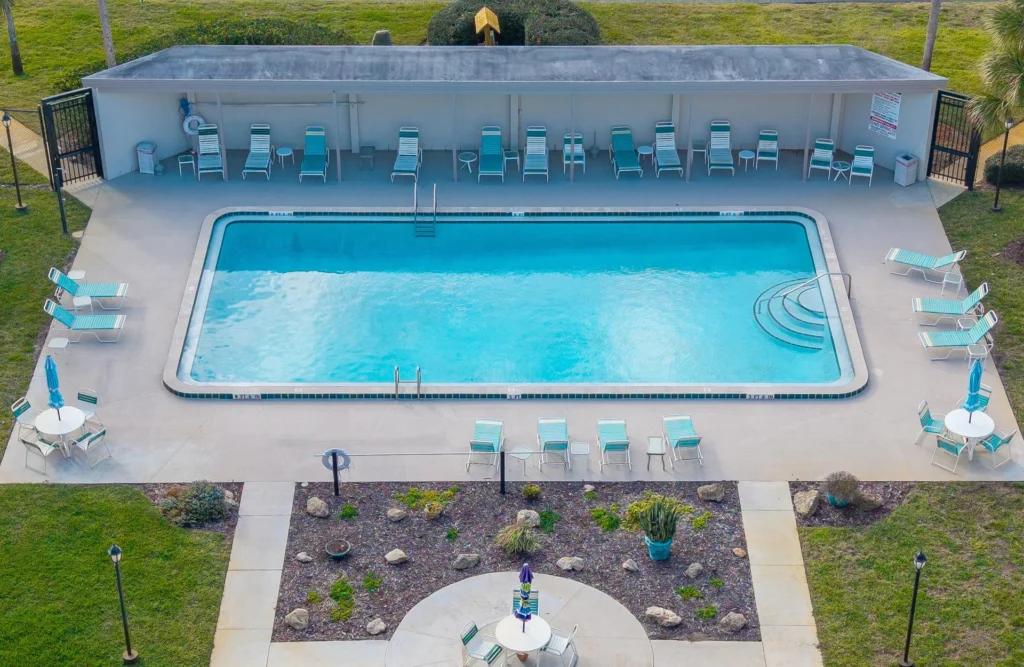 Sparkling pool with ample lounge seating for sunny relaxation