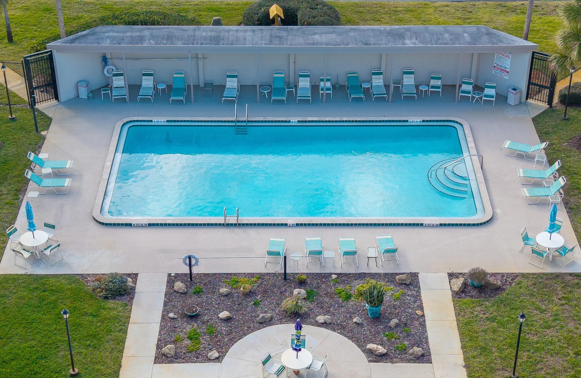 Sparkling pool with ample lounge seating for sunny relaxation