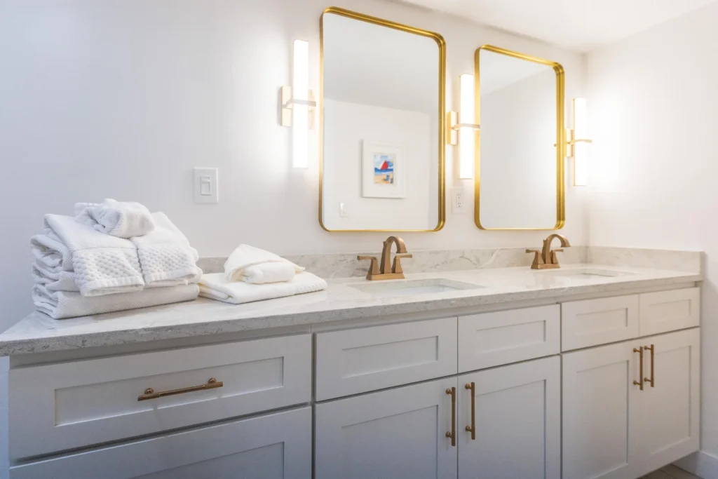 Ensuite, primary bathroom with dual vanities and elegant fixtures