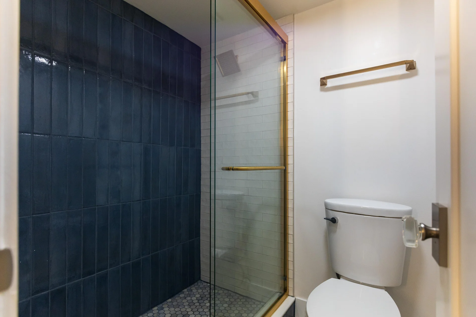 The primary bathroom with separate walk-in shower and toilet room