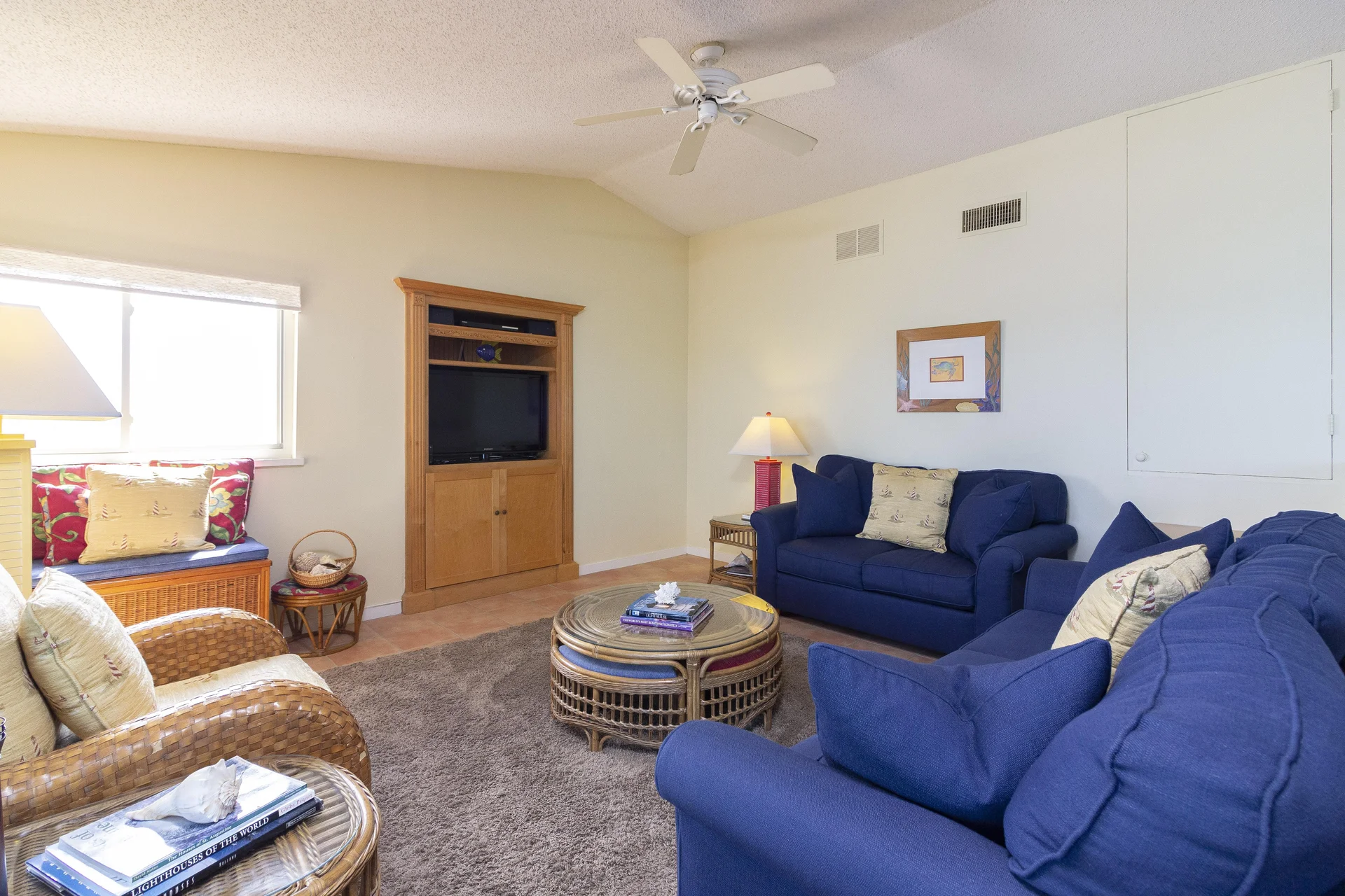 Entertainment center with flat-screen TV framed by natural wood cabinetry in the living room.