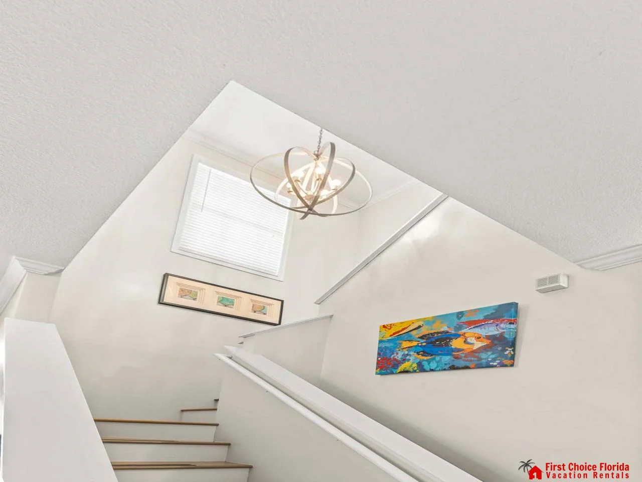 Bright stairwell with skylight and modern artwork