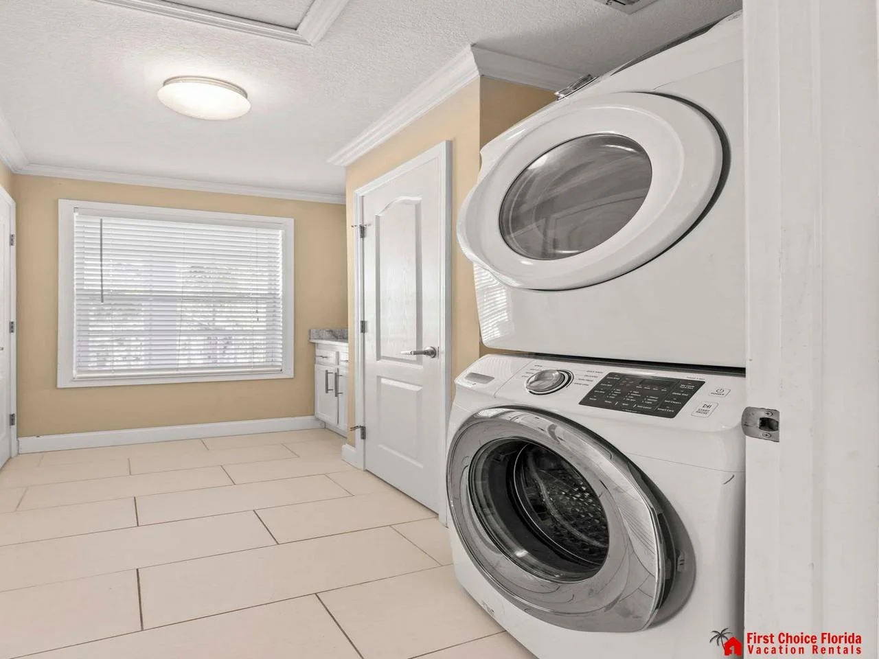 Bright laundry room with stacked washer and dryer for convenience