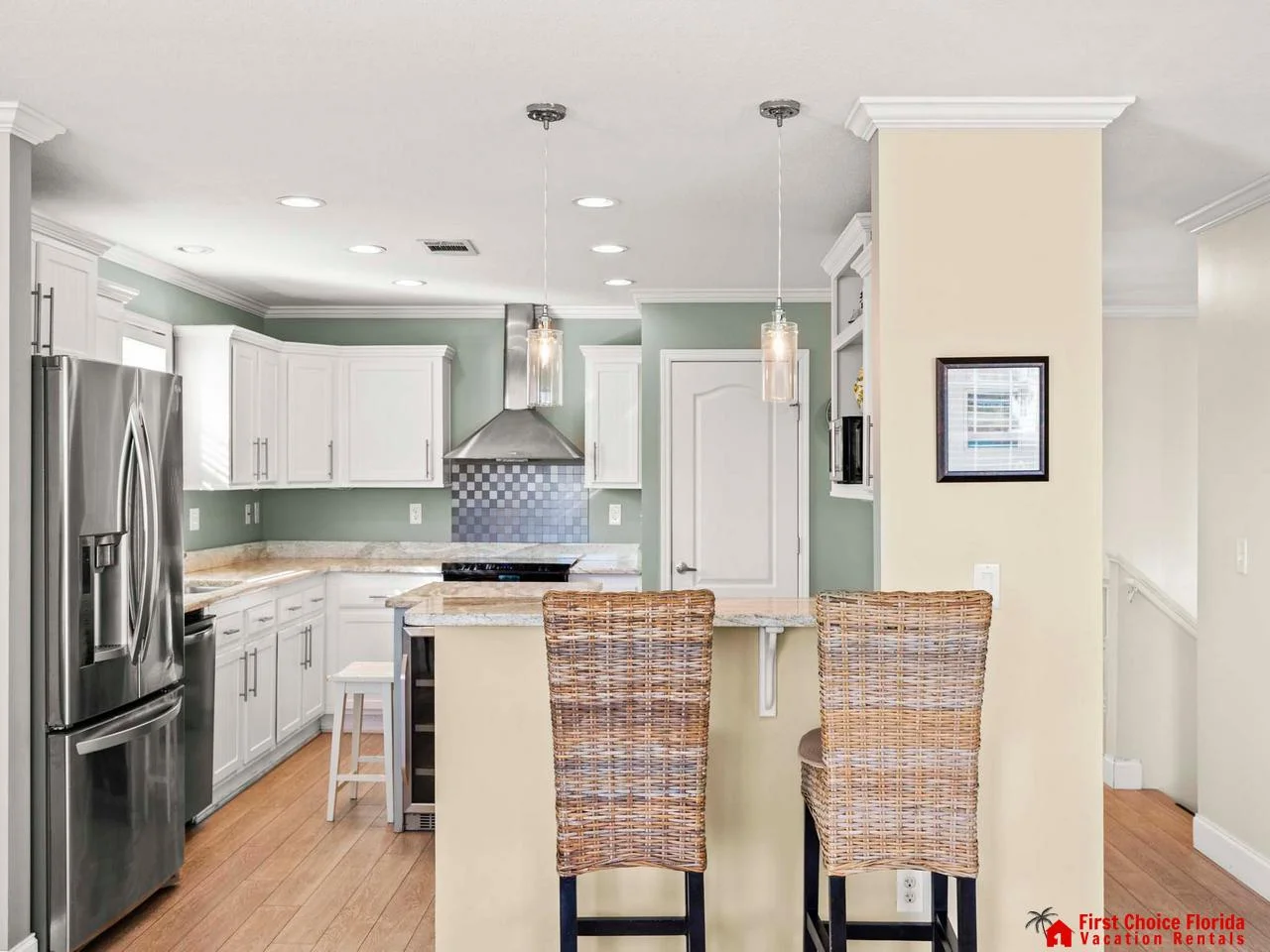 Modern kitchen with sleek appliances and cozy breakfast bar seating