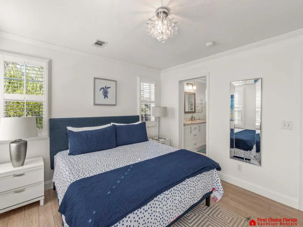 Bright and airy bedroom with cozy navy accents and natural light