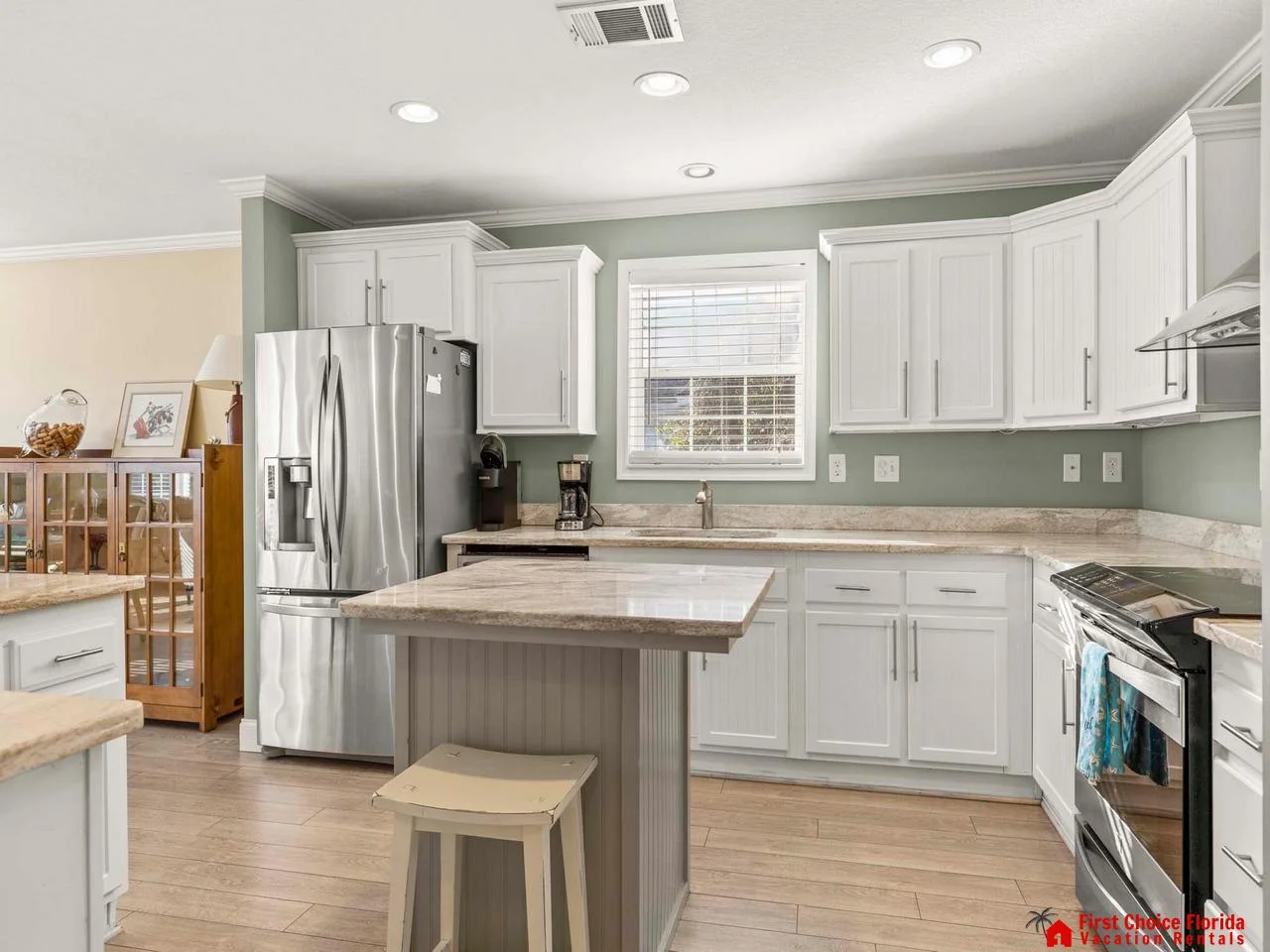Bright, modern kitchen with spacious island and stainless steel appliances