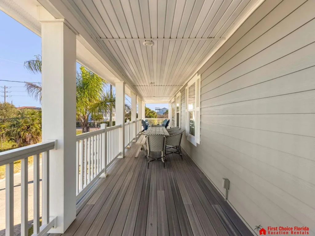 Spacious covered porch with cozy seating and scenic views
